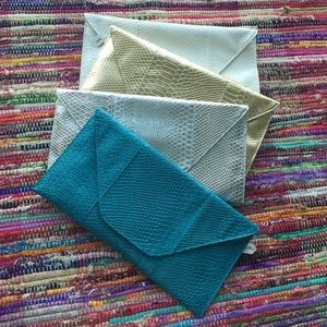 Oversized faux snake envelope clutch